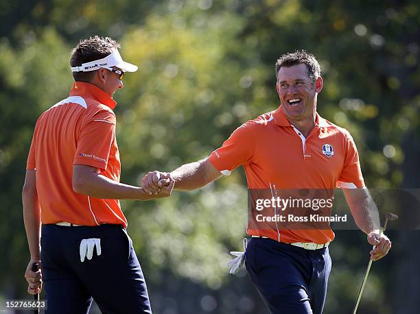 Lee Westwood and Ian Poulter of Europe share a joke during the second preview day of The 39th Ryder Cup at Medinah Country Golf Club on September 25,...