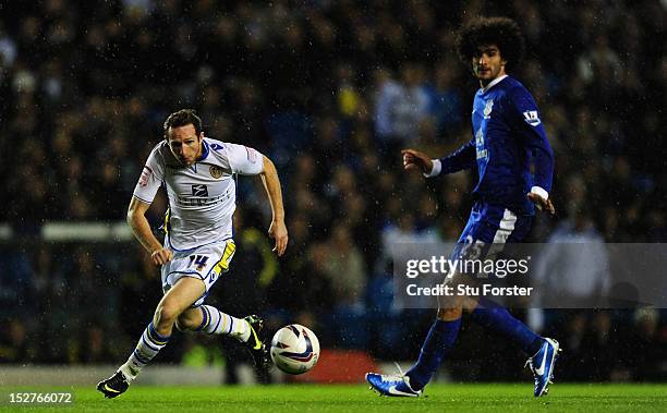 Leeds player Aidan White beats Everton player Marouane Fellaini to the ball during the Capital One Cup Third Round match between Leeds United and...