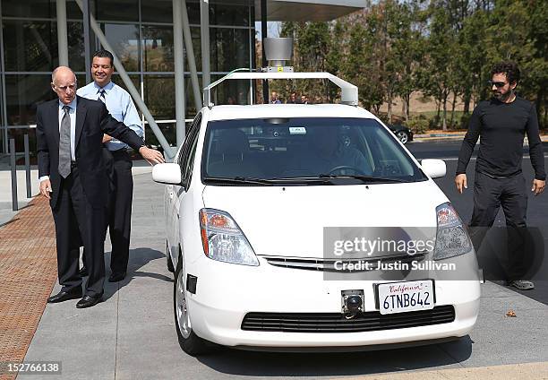 California Gov. Jerry Brown, California State Sen. Alex Padilla and Google co-founder Sergey Brin exit a self-driving car at the Google headquarters...