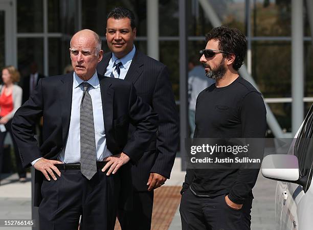 California Gov. Jerry Brown, California State Sen. Alex Padilla and Google co-founder Sergey Brin look on after riding in a self-driving car at the...