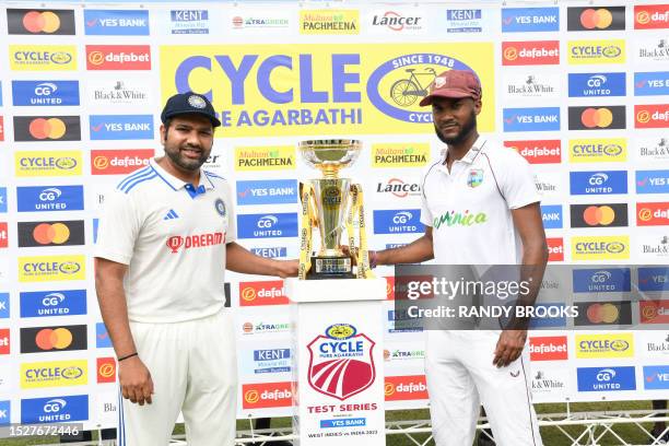 Rohit Sharma , of India, and Kraigg Brathwaite , of West Indies, pose for a photo after unveiling the series trophy during day one of the First Test...