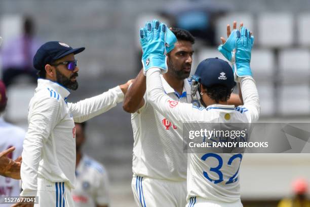 Ravichandran Ashwin , Ishant Sharma and Virat Kohli of India celebrate the dismissal of Tagenarine Chanderpaul of West Indies during day one of the...