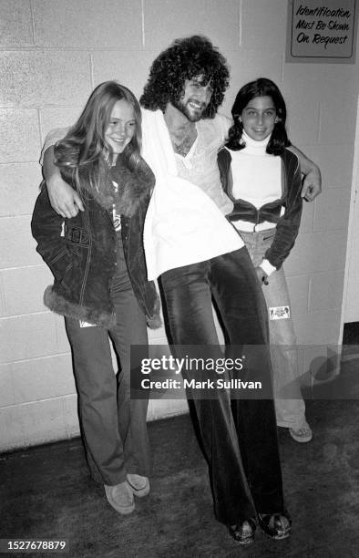 Musician Lindsey Buckingham poses with two fans after Fleetwood Mac's performance at The Forum, Inglewood, CA 1975.