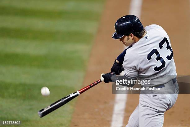 Nick Swisher of the New York Yankees hits a two run home run against the Minnesota Twins during the fourth inning of the game on September 25, 2012...