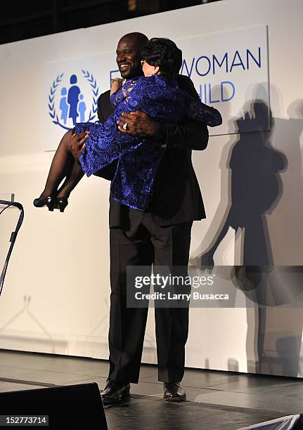 Shaquille O'Neal and Director-General of the World Health Organization Dr Margaret Chan pose onstage at the United Nations Every Woman Every Child...