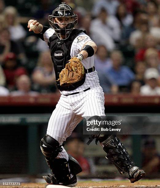 Chris Snyder of the Houston Astros steps on home plate to start a double play against the St. Louis Cardinals at Minute Maid Park on September 25,...