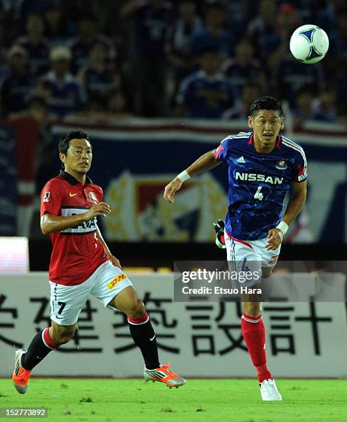 Yuzo Kurihara of Yokohama F.Marinos and Tsukasa Umesaki of Urawa Red Diamonds compete for the ball during the J.League match between Yokohama...