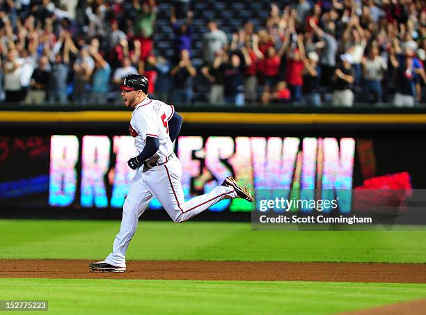 Freddie Freeman of the Atlanta Braves rounds the bases after hitting a 9th inning walk off home run against the Miami Marlins at Turner Field on...