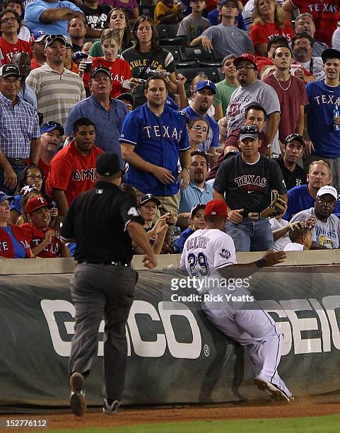 Wally Bell home plate umpire looks on as Adrian Beltre of the Texas Rangers runs for a pop fly but is late for the catch against the Oakland...