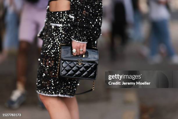 Melanie Kieback seen outside Chanel show wearing black barret, crystal earrings, black bandeau top, glittery Chanel jacket and matching skirt,...