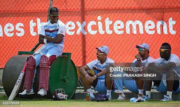West Indies cricketers Darren Bravo talks with Sunil Narine , Ravi Rampaul and Andre Russell during a training session at the Pallekele International...