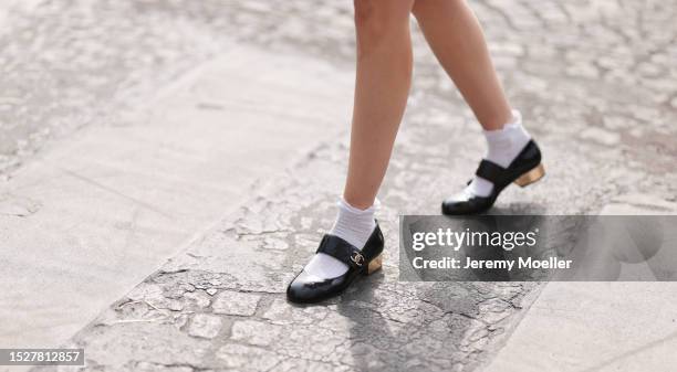 Guest seen outside Chanel show wearing white ruffled socks and black Chanel loafers during the Haute Couture Fall/Winter 2023/2024 as part of Paris...