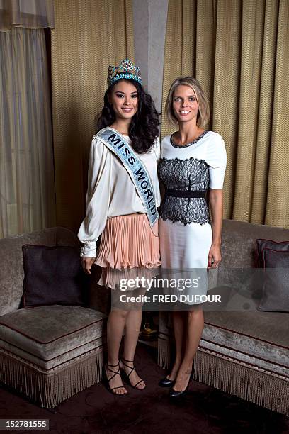 Chinese Miss World 2012 Wenxia Yu and Miss France 2002 Sylvie Tellier pose at the hotel Fouquet's on September 26, 2012 in Paris. AFP PHOTO / FRED...