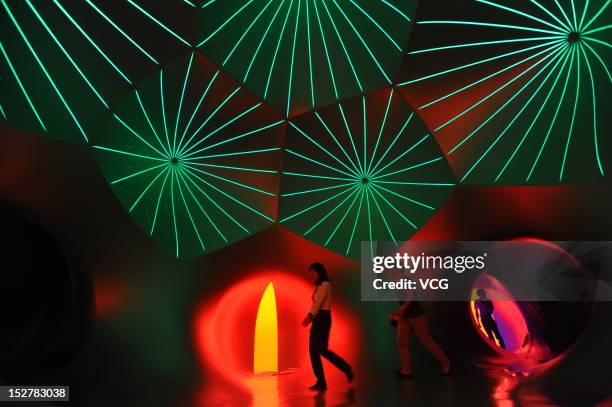 People walk inside the Miracoco Luminarium, an inflatable sculpture by British artist Alan Parkinson of Architects of Light, at Evergreen Garden...