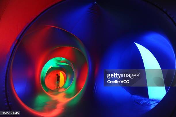 People walk inside the Miracoco Luminarium, an inflatable sculpture by British artist Alan Parkinson of Architects of Light, at Evergreen Garden...