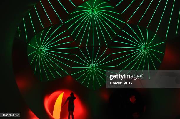 People walk inside the Miracoco Luminarium, an inflatable sculpture by British artist Alan Parkinson of Architects of Light, at Evergreen Garden...