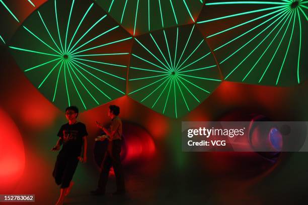 People walk inside the Miracoco Luminarium, an inflatable sculpture by British artist Alan Parkinson of Architects of Light, at Evergreen Garden...