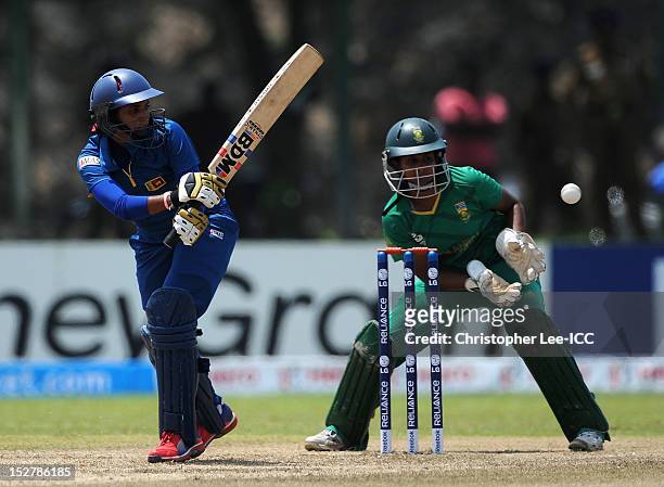Chamani Senevirathne of Sri Lanka guides the ball towards the boundary as Trisha Chetty of South Africa watches during the ICC Women's World Twenty20...