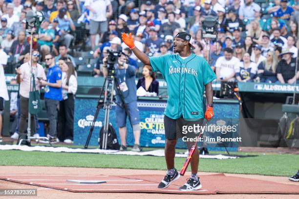 Former MLB All-Star Adam Jones talks to the pitcher at T-Mobile Park on July 08, 2023 in Seattle, Washington.