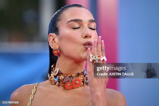 English singer-songwriter Dua Lipa blows a kiss on the pink carpet upon arrival for the European premiere of "Barbie" in central London on July 12,...