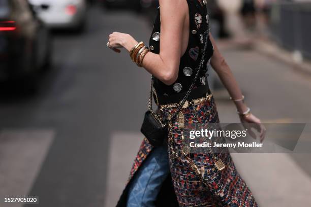 Maria Helena Bordon Meireles seen outside Chanel show wearing Chanel earrings, black sunnies, Chanel logo tank top in black, Chanel belt, Chanel...