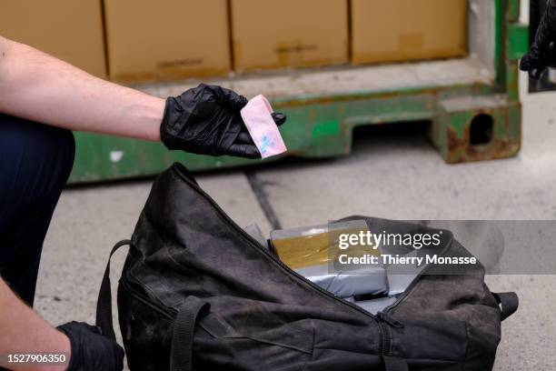 Custom officer shows to media the result of reactive wipes with cocaine in a container on July 11, 2023 in the Port of Antwerp, Kallo, Beveeren,...