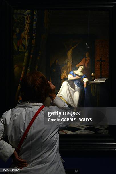 Visitor looks at "The Allegory of the Catholic Faith" by Dutch artist Johannes Vermeer during the media preview of the exhibition of "Vermeer. Il...