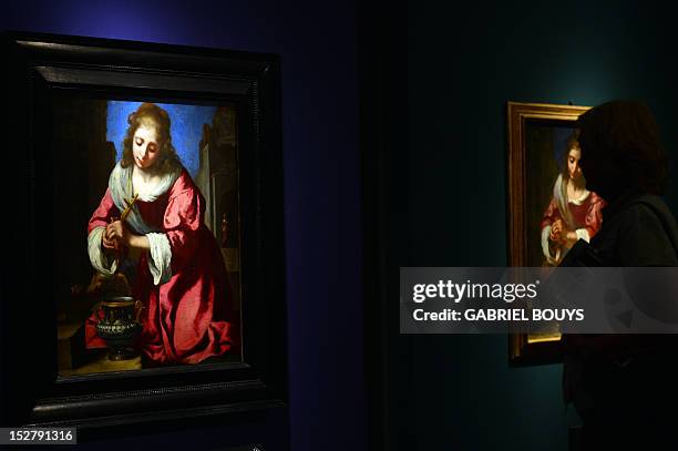 Visitor looks at "St. Praxedis" by Dutch artist Johannes Vermeer during the media preview of the exhibition of "Vermeer. Il secolo d’oro dell’arte...