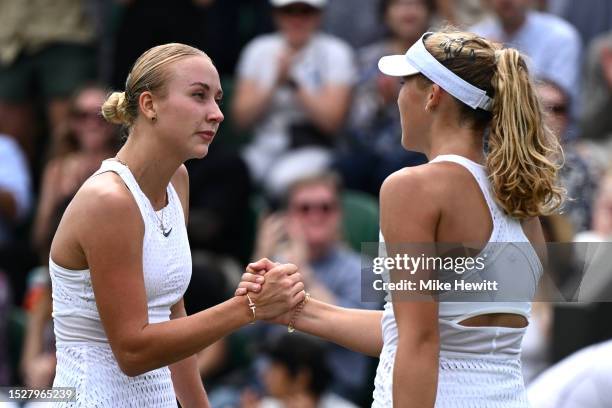 Anastasia Potapova shakes hands with Mirra Andreeva following the Women's Singles third round match during day seven of The Championships Wimbledon...