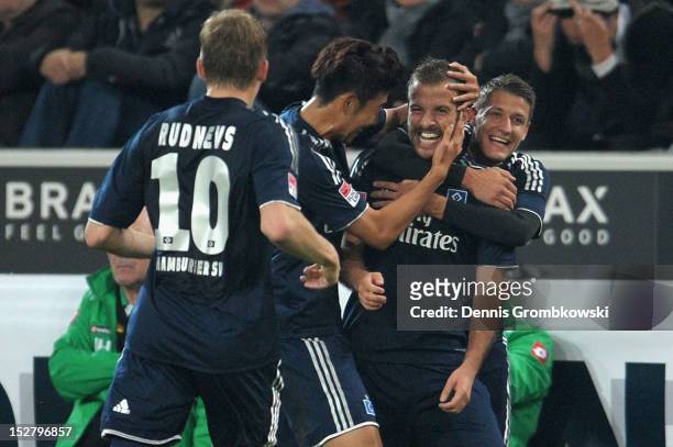 Rafael van der Vaart of Hamburg celebrates with teammates after scoring his team's first goal during the Bundesliga match between Borussia...