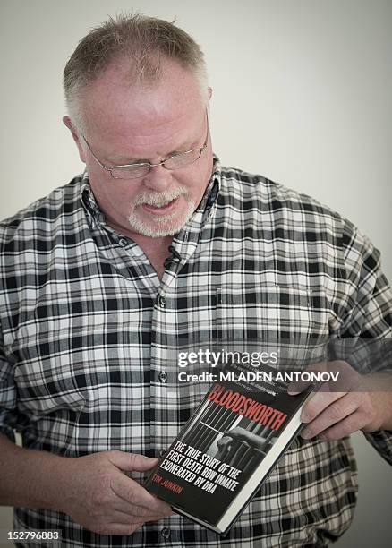 Kirk Bloodsworth shows a book written about him during an interview in his apartment in Mount Rainier, Maryland on September 26, 2012. Kirk...