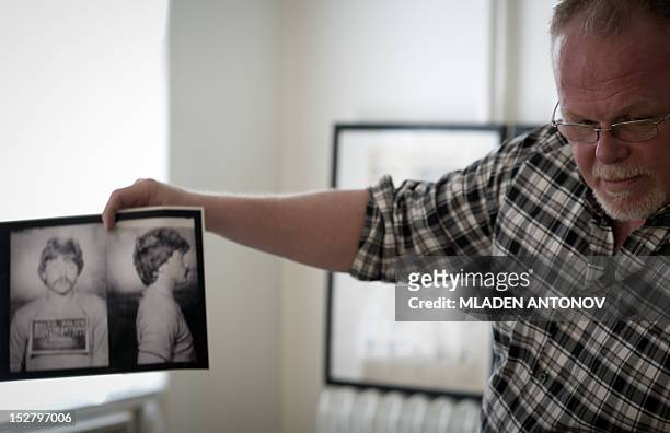 Kirk Bloodsworth shows pictures of the convicted murderer Kimberly Shay Ruffner during an AFP interview in his apartment in Mount Rainier, Maryland...