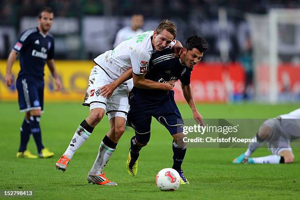 Luuk de Jong of Moenchengladbach challenges Tolgay Arslan of Hamburg during the Bundesliga match between Borussia Moenchengladbach and Hamburger SV...