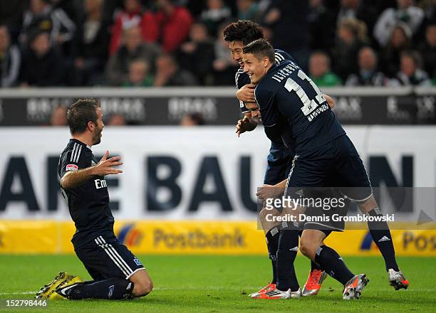Artjoms Rudnevs of Hamburg celebrates with teammates after scoring his team's second goal during the Bundesliga match between Borussia...
