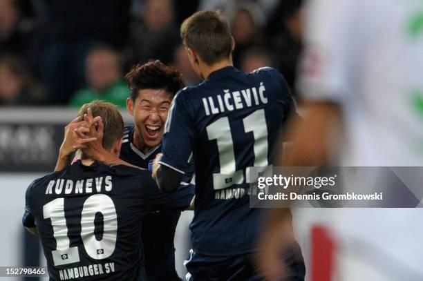 Artjoms Rudnevs of Hamburg celebrates with teammate Heung Min Son after scoring his team's second goal during the Bundesliga match between Borussia...