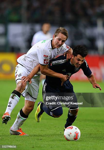 Luuk de Jong of Moenchengladbach challenges Tolgay Arslan of Hamburg during the Bundesliga match between Borussia Moenchengladbach and Hamburger SV...