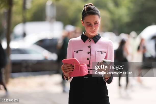 Sabina Jakubowicz seen outside Chanel show wearing Chanel headband, rose colored glasses, rose Chanel tweed jacket, black Chanel skirt, pink Chanel...