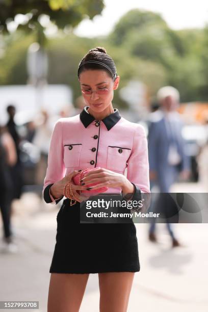 Sabina Jakubowicz seen outside Chanel show wearing Chanel headband, rose colored glasses, rose Chanel tweed jacket, black Chanel skirt, pink Chanel...