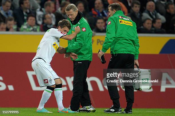 Patrick Herrmann of Moenchengladbach is treated after suffering an injury during the Bundesliga match between Borussia Moenchengladbach and Hamburger...