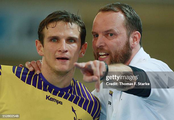 Hwad coach Dagur Sigurdsson of Berlin gives advice to his players Bartlomiej Jaszka during the Toyota Handball Bundesliga match between TuS...