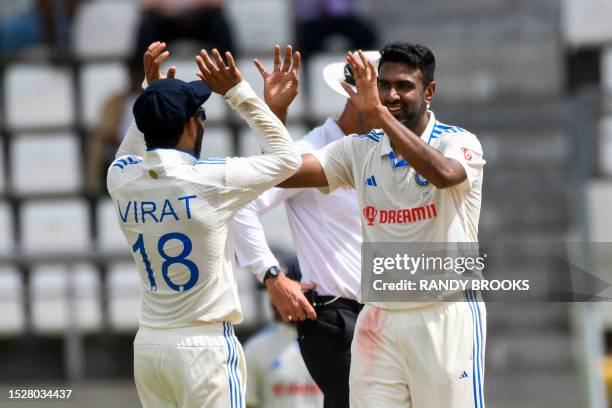 Ravichandran Ashwin and Virat Kohli of India celebrates the dismissal of Alzarri Joseph of West Indies during day one of the First Test between West...