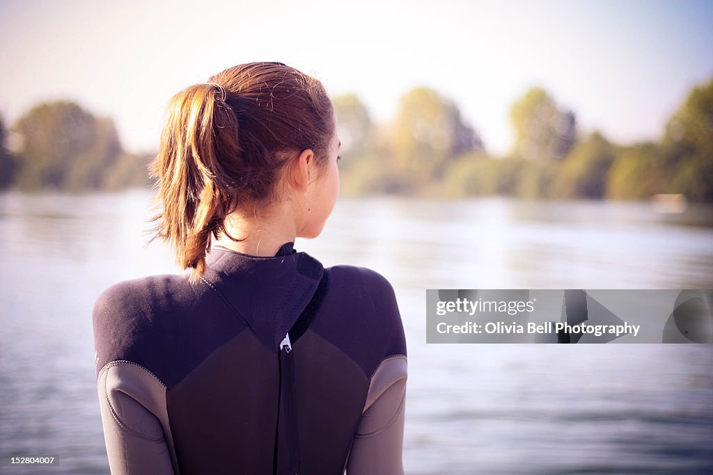 Girl sitting near lake