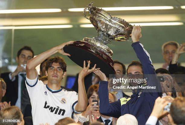 Kaka and Gonzalo Higuain of Real Madrid lift the trophy after winning the Santiago Bernabeu Trophy match between Real Madrid and Millonarios CF at...