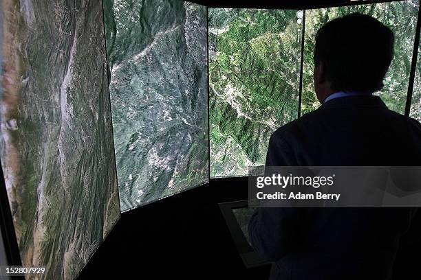 Visitor looks at a three-dimensional rendering of French mountains using Google Earth software on September 26, 2012 at the official opening party of...