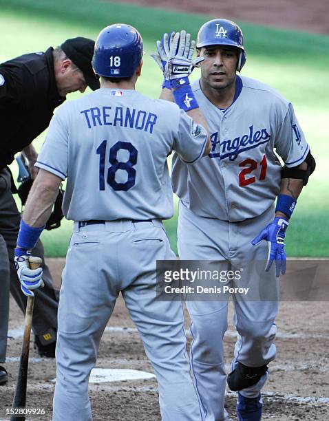 Juan Rivera of the Los Angeles Dodgers is congratulated by Matt Treanor after hitting a solo home run during the fourth inning of a baseball game...