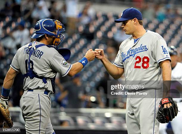 Jamey Wright of the Los Angeles Dodgers, right, is congratulated by Matt Treanor after getting the final out in the ninth inning of a baseball game...