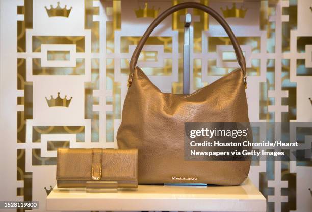 Elaine Tuner Madelyn Patina Metallic Gold Leather Hobo for sale for $398 and a the Continental Wallet for $198. Tuesday, Aug. 19 in Houston.