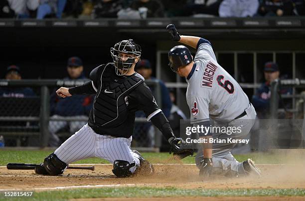 Lou Marson of the Cleveland Indians scores past catcher A.J. Pierzynski of the Chicago White Sox after Shin-Soo Choo grounded out to first base...
