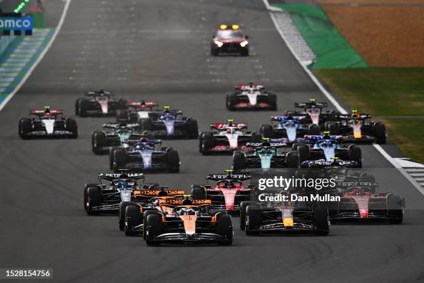 Lando Norris of Great Britain driving the McLaren MCL60 Mercedes leads Max Verstappen of the Netherlands driving the Oracle Red Bull Racing RB19 and...