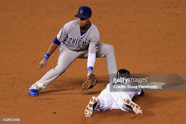 Andrew Brown of the Colorado Rockies steals second base as shortstop Starlin Castro of the Chicago Cubs takes the throw in the sixth inning at Coors...